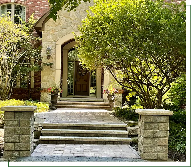 A stone walkway leading to the entrance of a house.